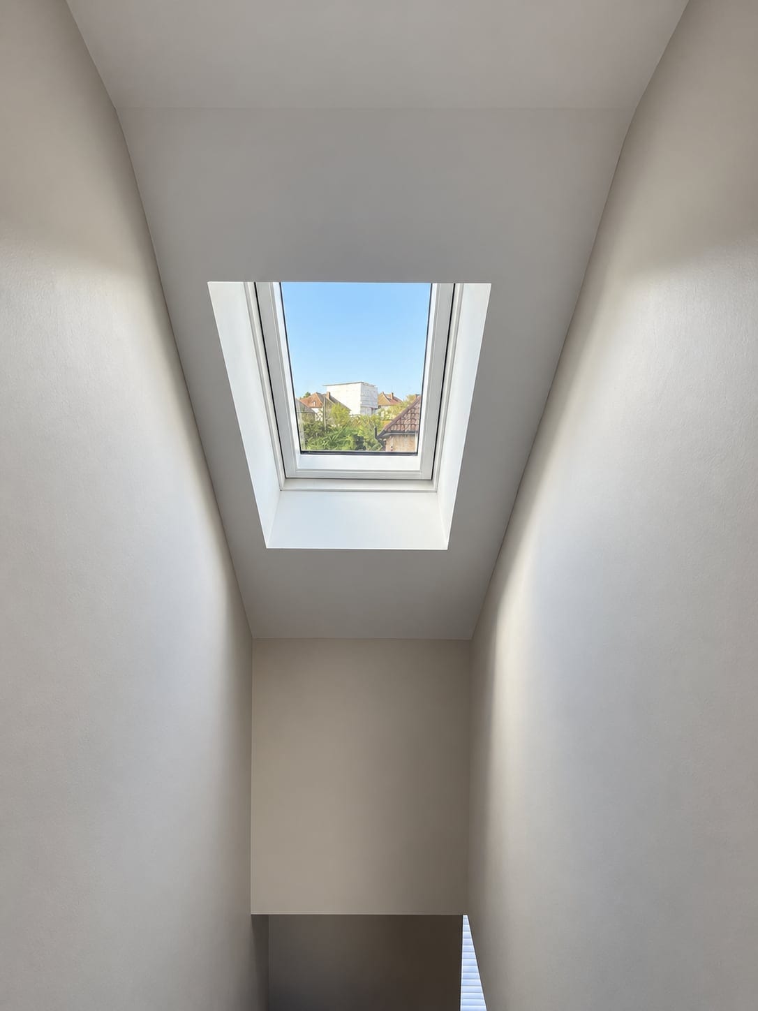 Top of the loft stair lit by a rooflight