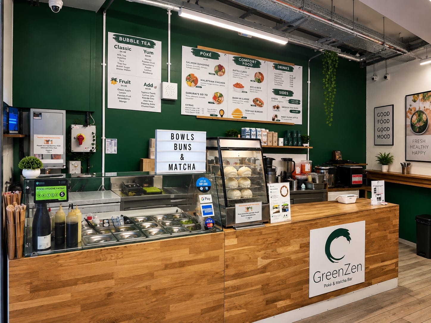 Oak-clad service counter with food displays and menus against a green wall