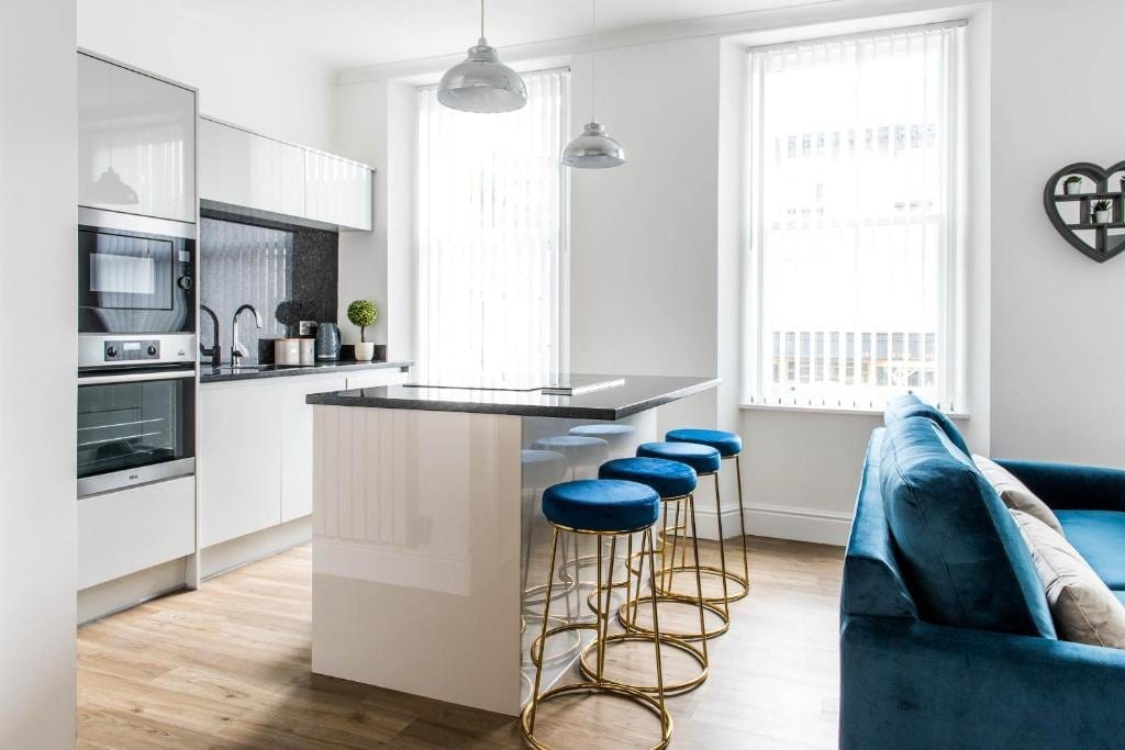 Kitchen island with stools beside the living area