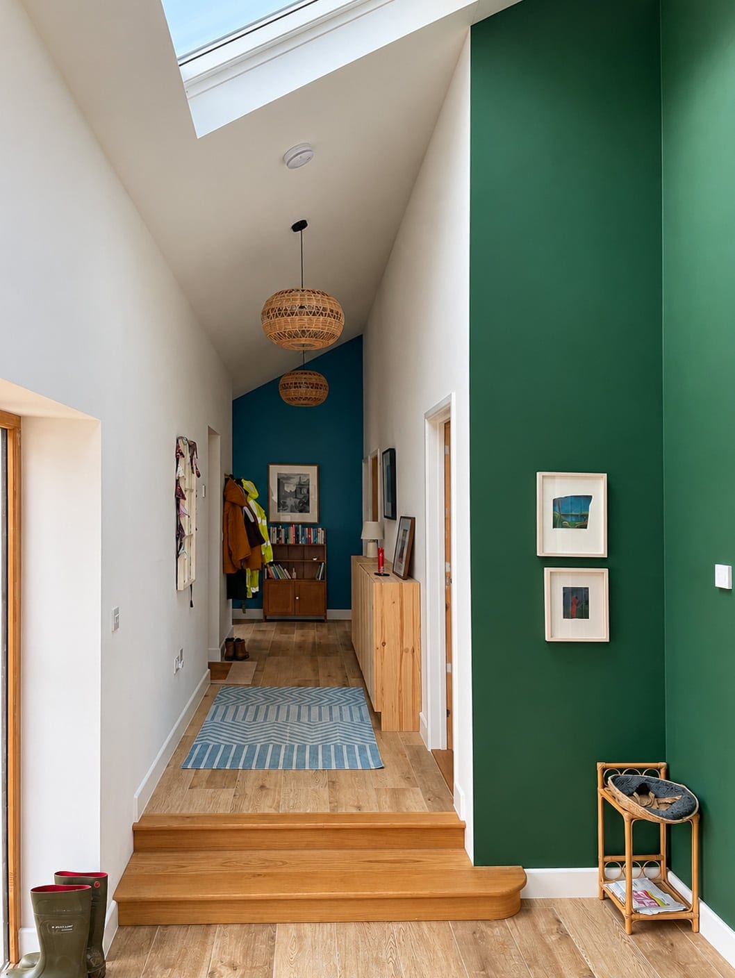 Corridor with timber steps, rooflights and a green feature wall