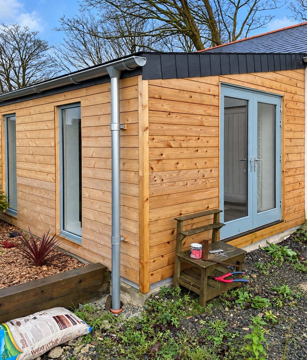 Corner of the timber-clad extension with glazed doors