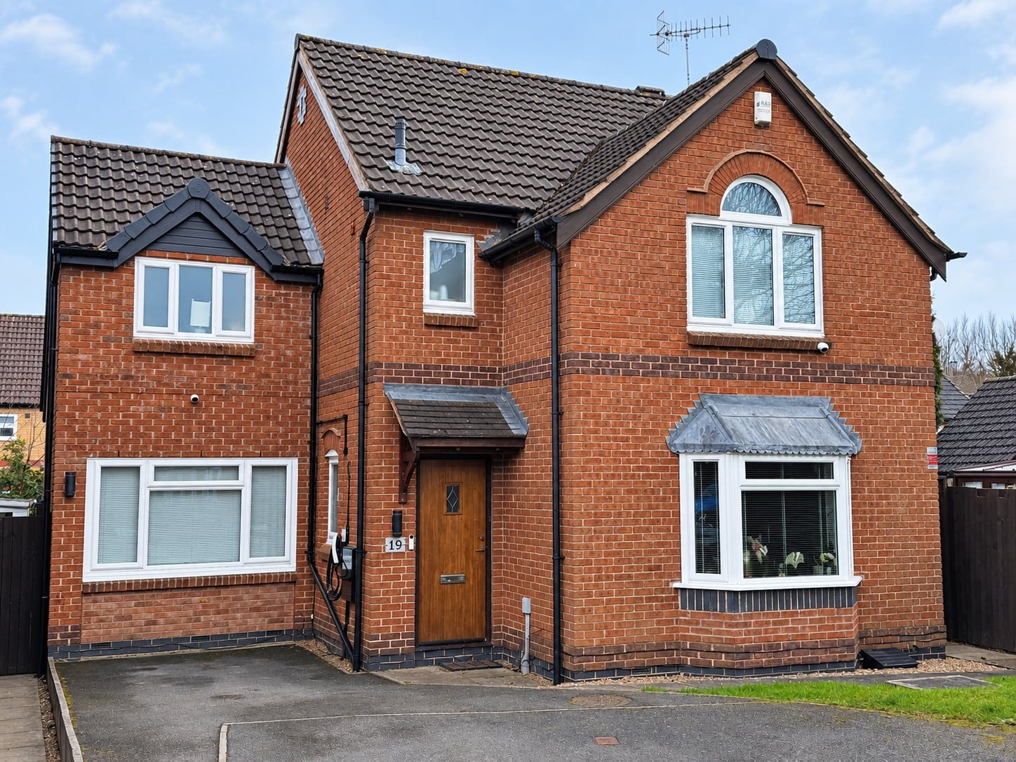 Front of the brick family home with its first-floor side extension