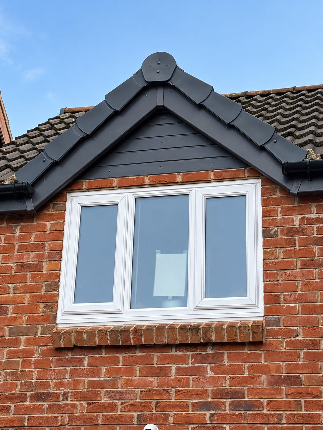 First floor window beneath a small gable