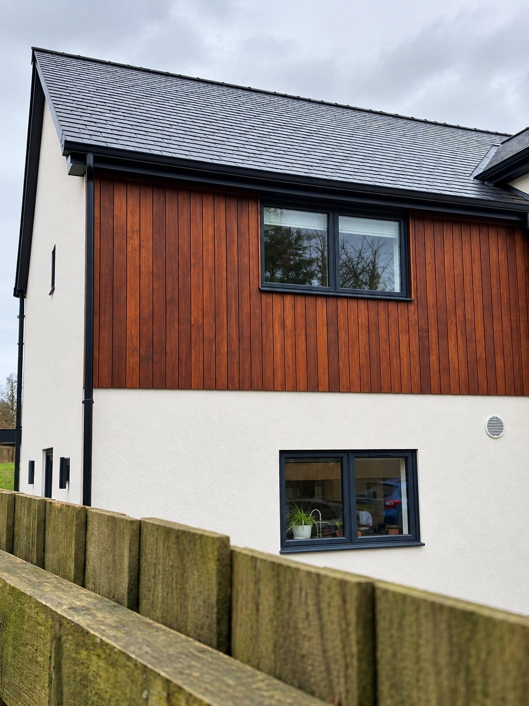 Vertical timber cladding above white render