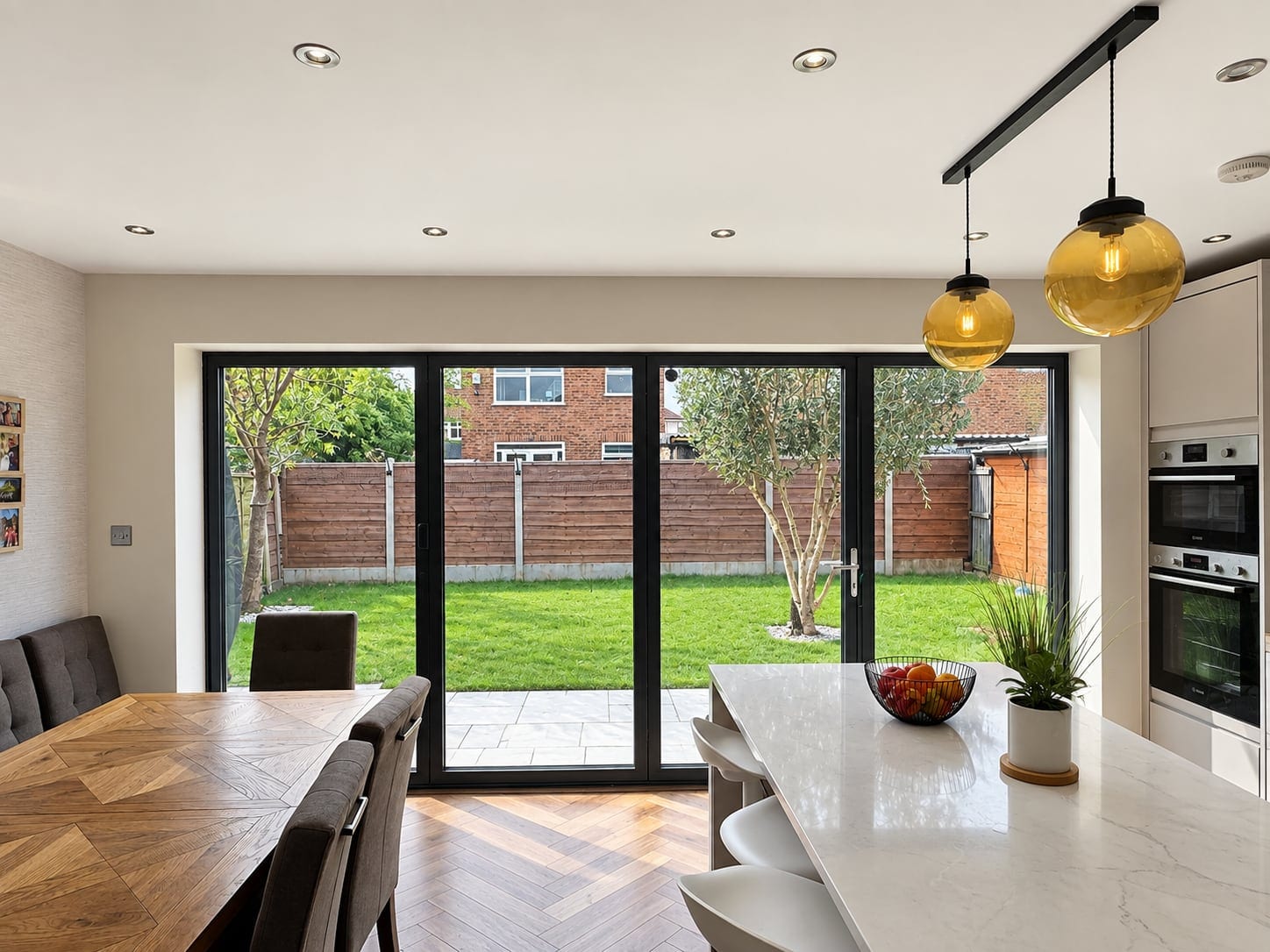 Dining table looking out through glazed doors to the garden