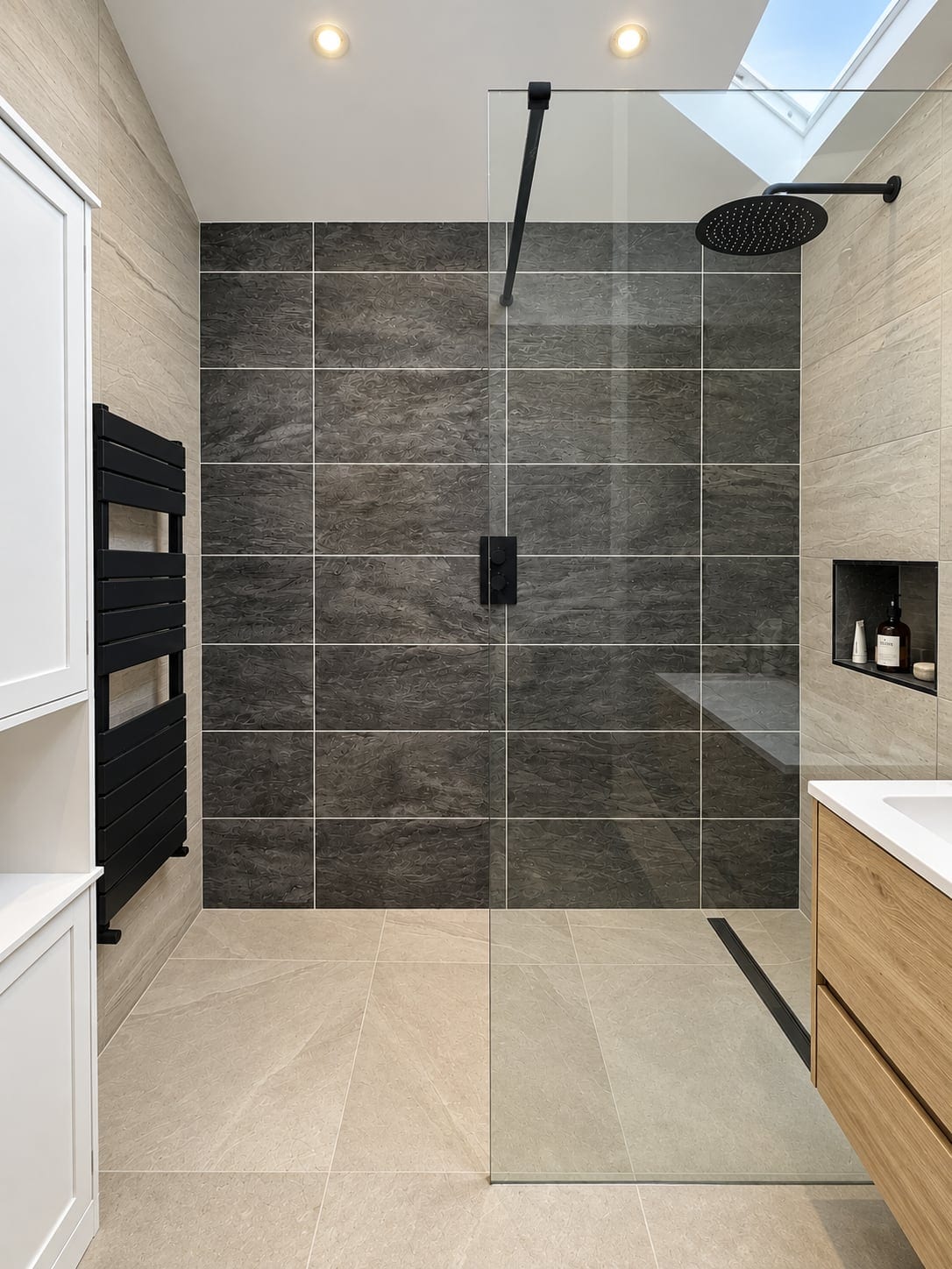 Walk-in shower with dark tiles and a rooflight