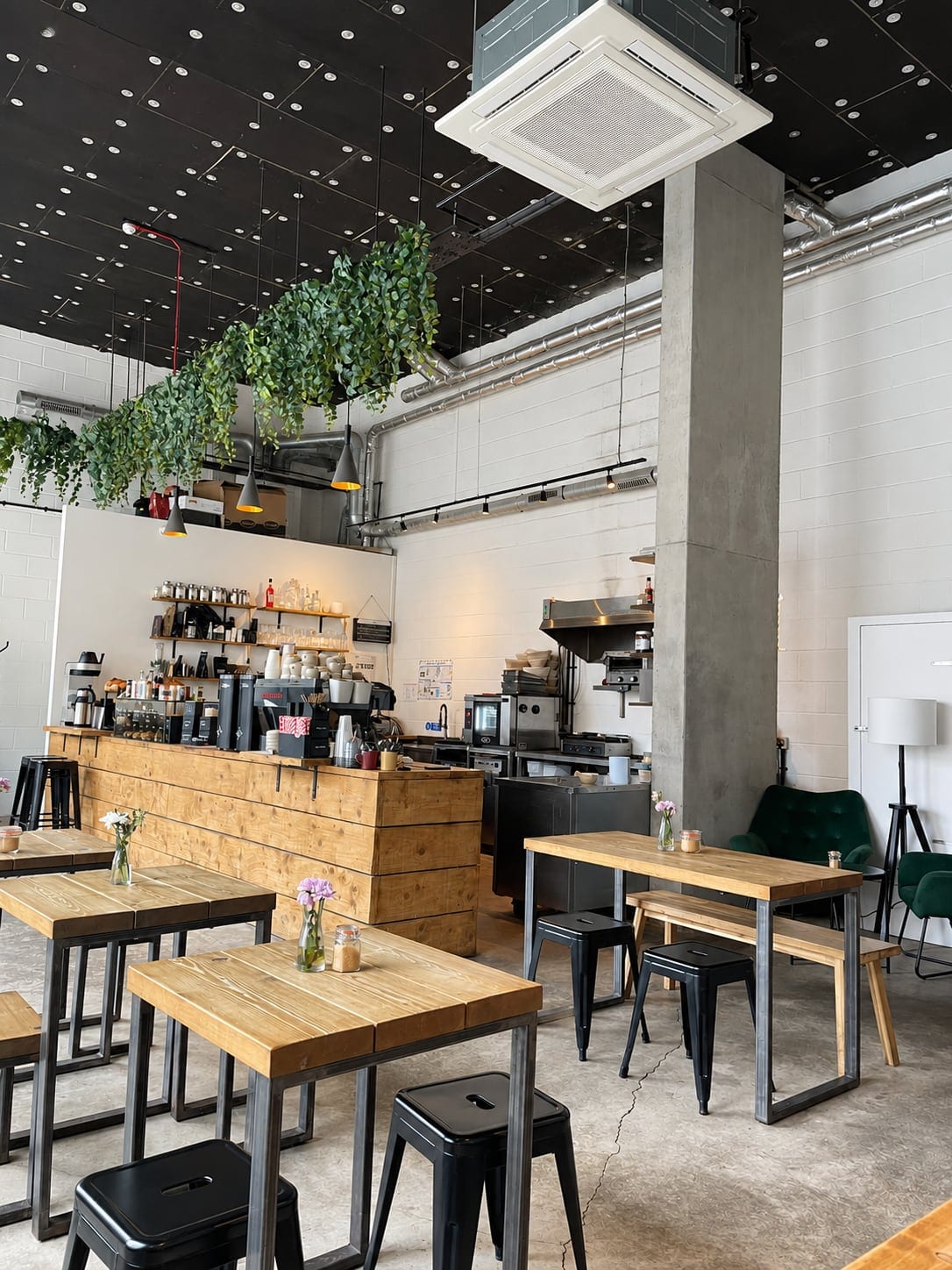 View across the seating to the counter, with exposed services above