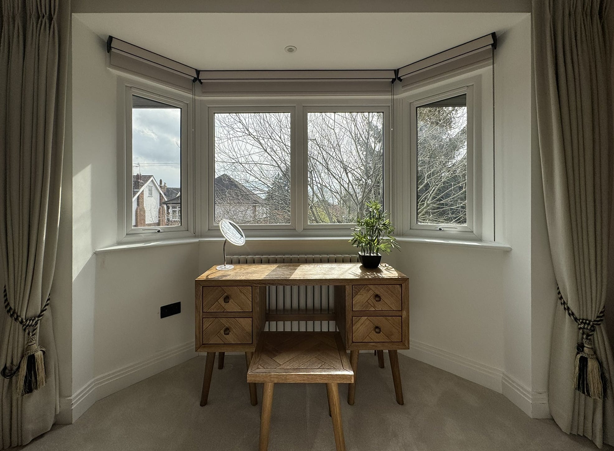 Bay window with a desk and curtains