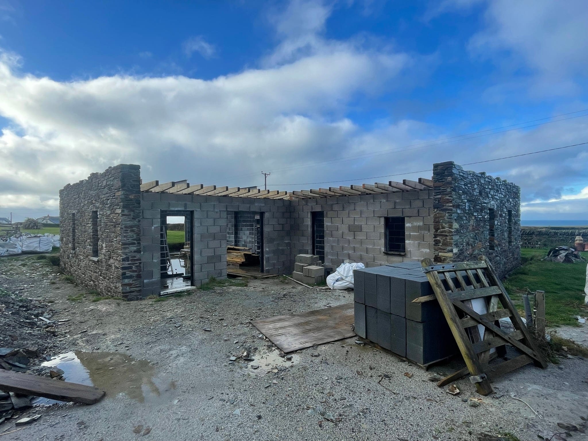 Construction: the full stone-and-block form of the house taking shape