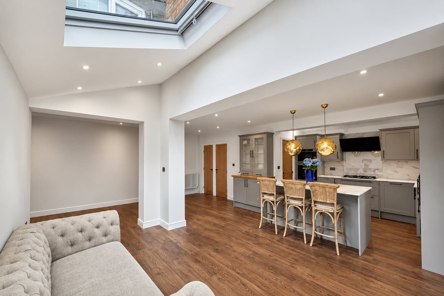 Kitchen and living area beneath a rooflight