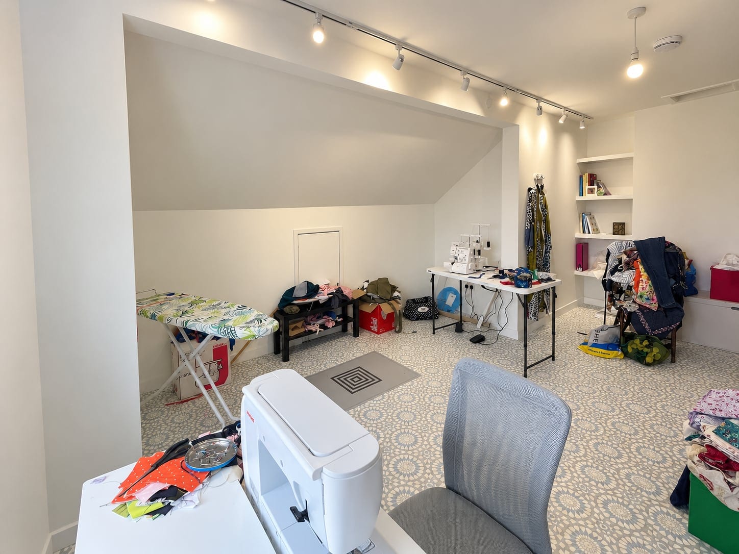 The studio in use, with a sewing machine and ironing board