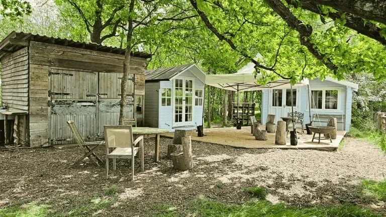Cabins, deck and outdoor seating in the woodland