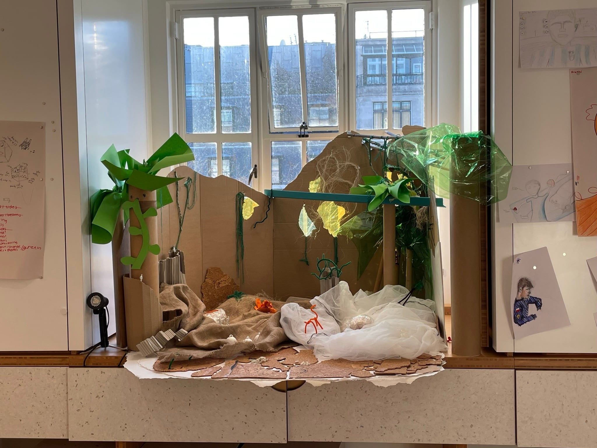 A participant's model of a dwelling made from card, fabric and plants